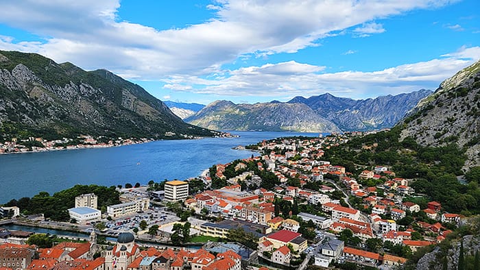 Image of Kotor Bay with red tiled roofs. Towns like this are one of many reasons for why visit Montenegro.