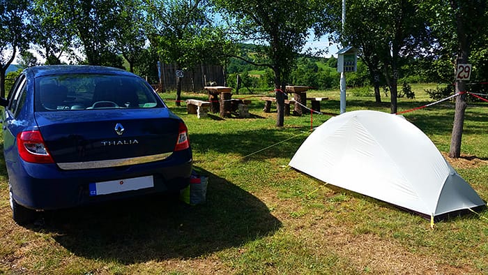 image of a car and tent in a campground