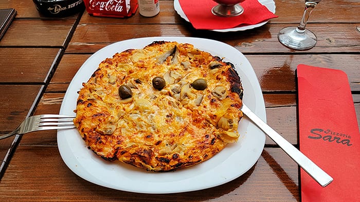 4_Pizza in Montenegro Image of a pizza on a table. Why visit Montenegro? The food!
