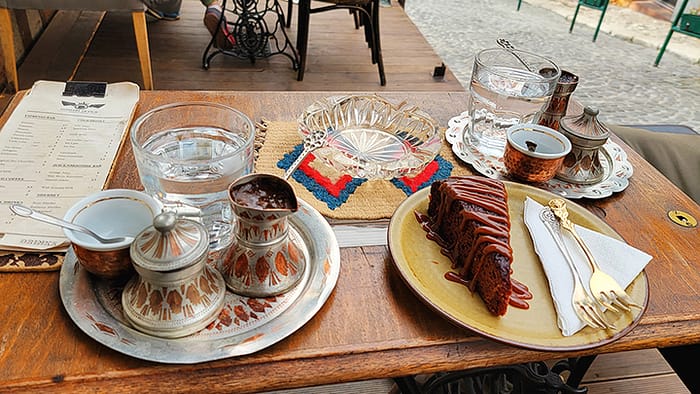 image of a table with traditional Bosnian coffee and date cake from a restaurant in Sarajevo