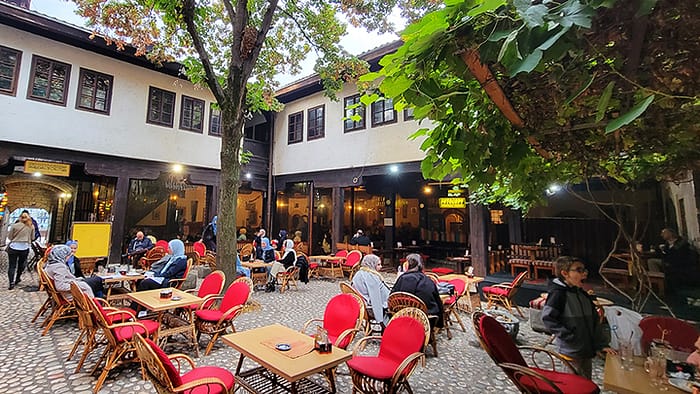 image of a large courtyard with tables and trees