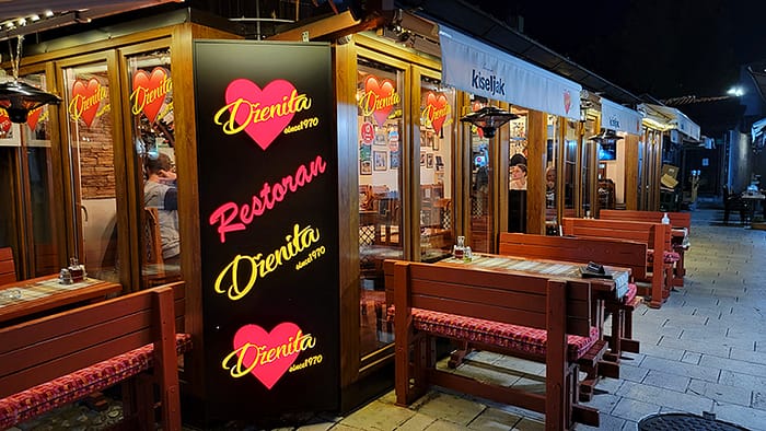 image of the exterior of a traditional Bosnian restaurant in Sarajevo at night