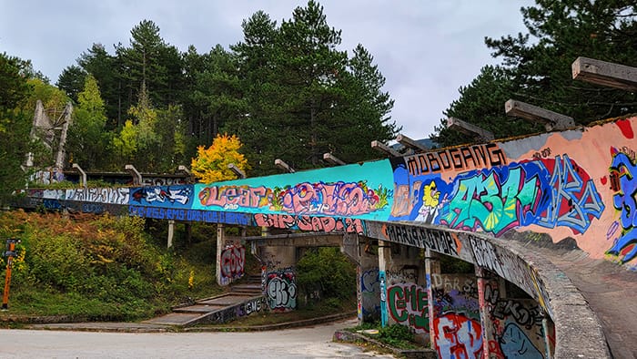 picture of the abandoned bobsled track from the 1984 Olympics covered in urban art
