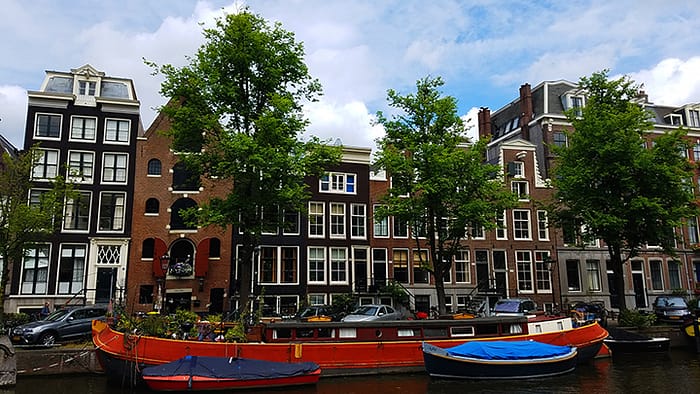 image of houses lining the canals in Amsterdam, one of the more expensive destinations if you're planning your budget for travel in europe
