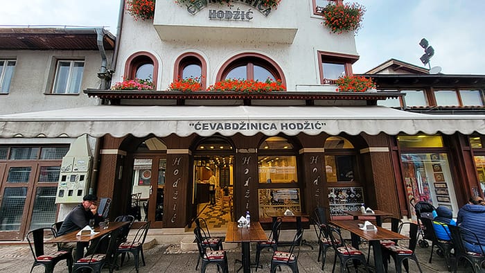 image of the outside of a cevapi restaurant in Sarajevo with outdoor seating