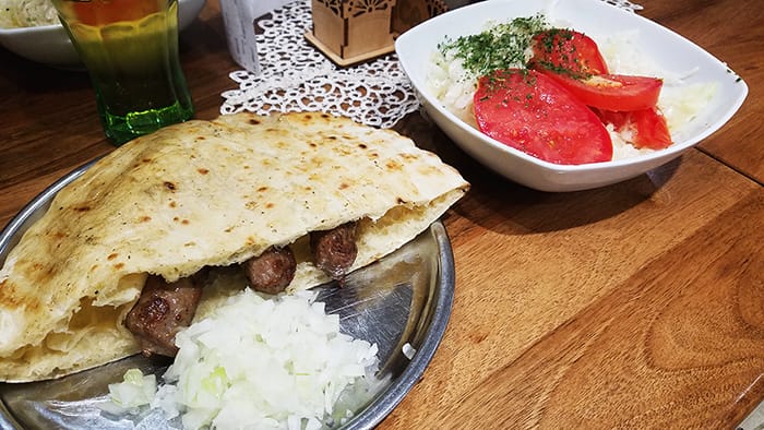 cevapi and salad picture of a Balkan food staple cevapi and salad
