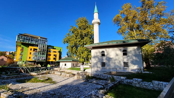 image of an old synagogue next to a colorful modern building