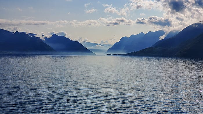 image of water and cliffs in the distance from the fjords of Norway