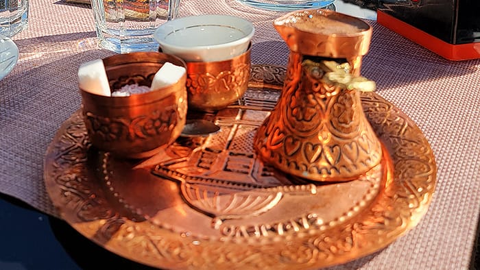 image of a small table with a copper setting of traditional Bosnian coffee